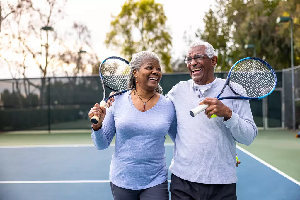 two people playing tennis. 