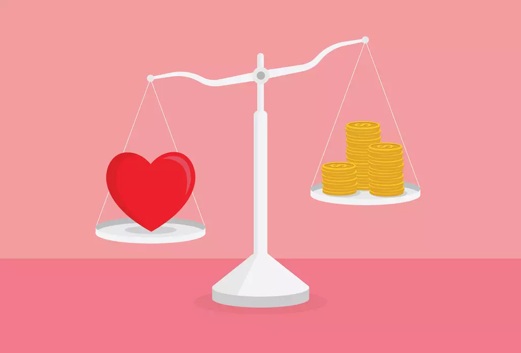 scale with a heart on the left and money on the right